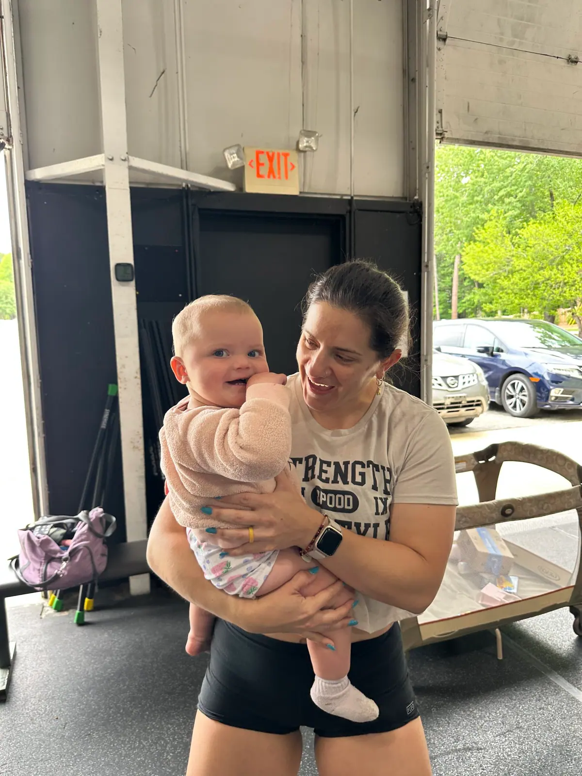 Family-friendly CrossFit community supporting a new mom during a workout at CrossFit Coordinate in Cary, NC