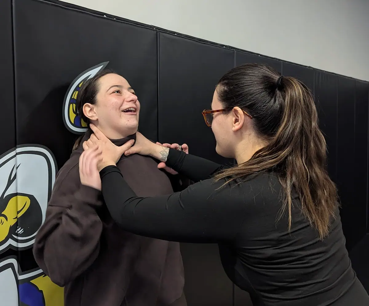CrossFit Coordinate women smiling while learning self-defense and jiu-jitsu in Cary NC