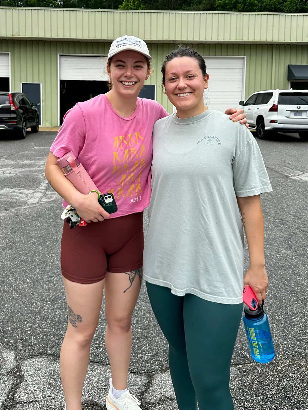 Two CrossFit Coordinate members smiling together outside the gym on Memorial Day before tackling Murph
