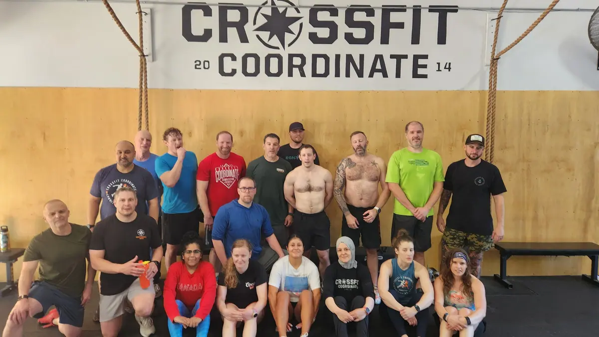 Candid group photo of all 2026 Ergathlon participants under the CrossFit Coordinate gym logo