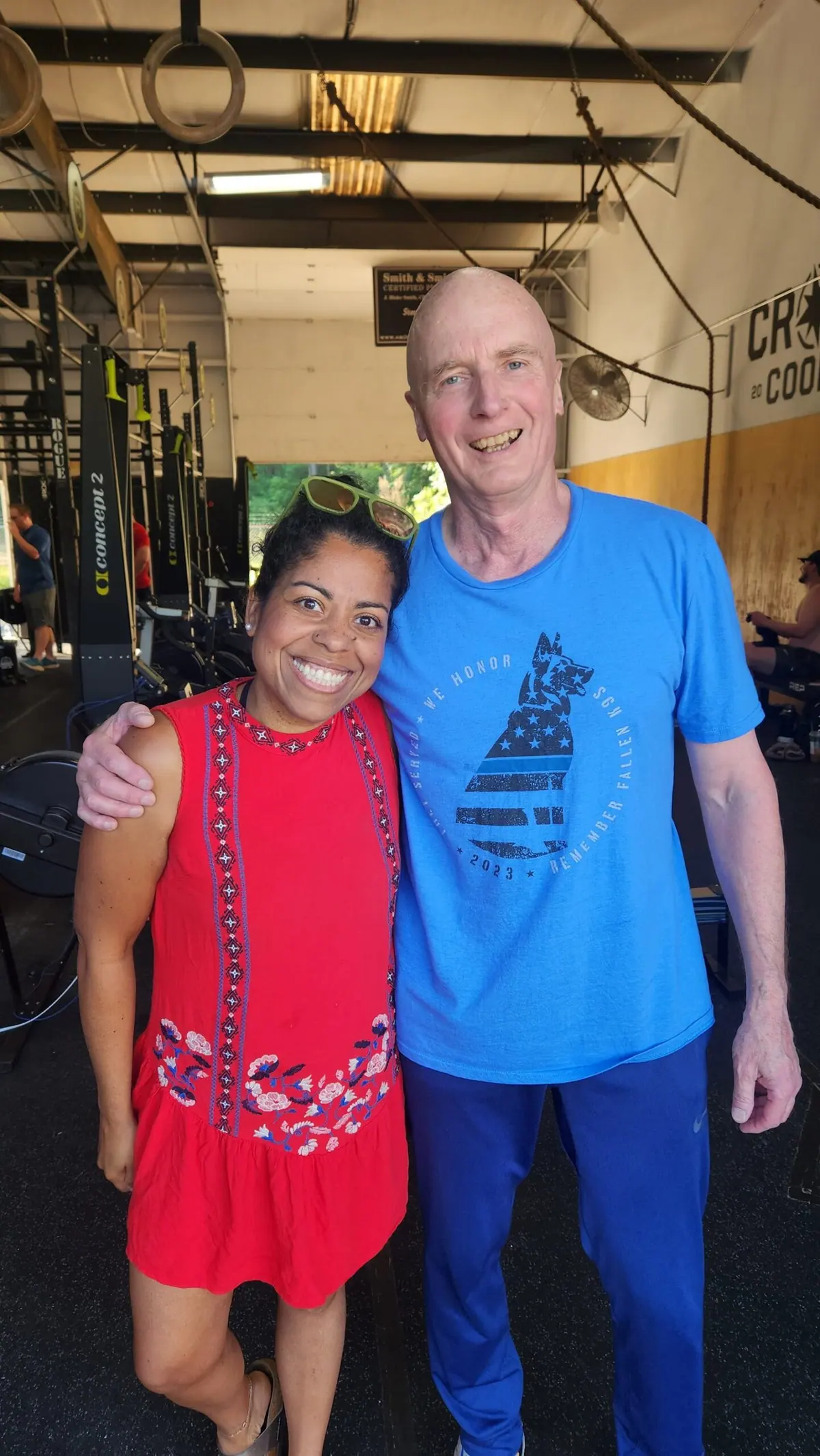 Two CrossFit Coordinate athletes smiling together under the gym rafters during the 2026 Ergathlon