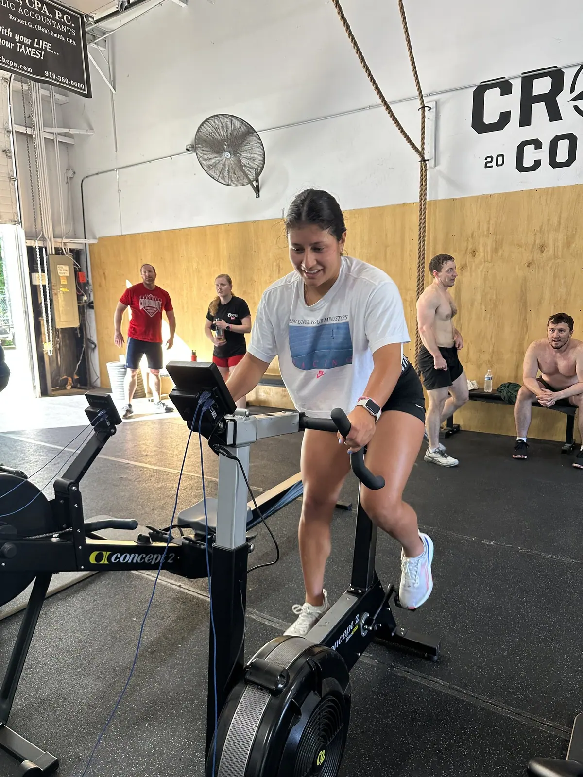 CrossFit Coordinate athlete pushing hard through the 10,000m bike erg leg on a Concept2 BikeErg