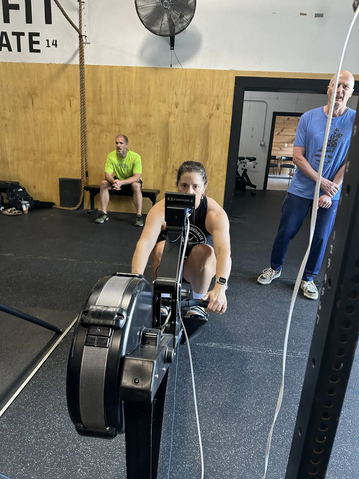 A teammate pulling hard on the Concept2 rower during the Ergathlon