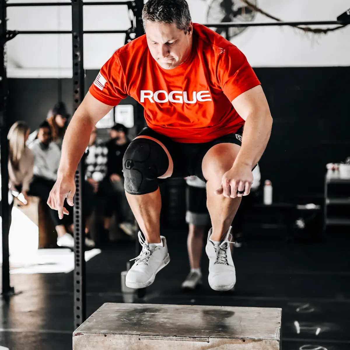 Patrick Williams mid-air on a box jump during a CrossFit workout at CrossFit Coordinate in Cary, NC